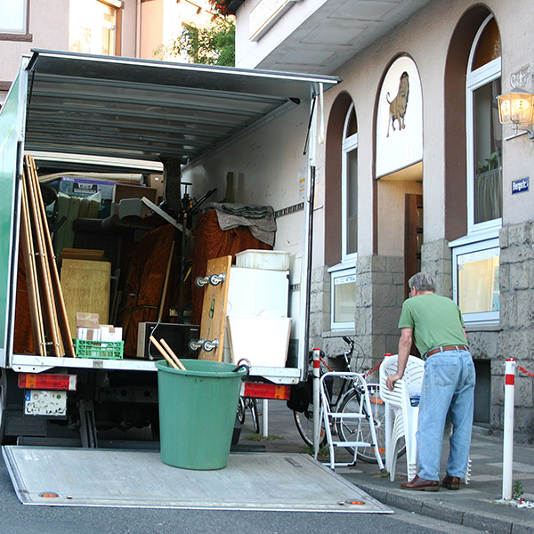 Ein Umzugswagen wird vor einem Altbau beladen